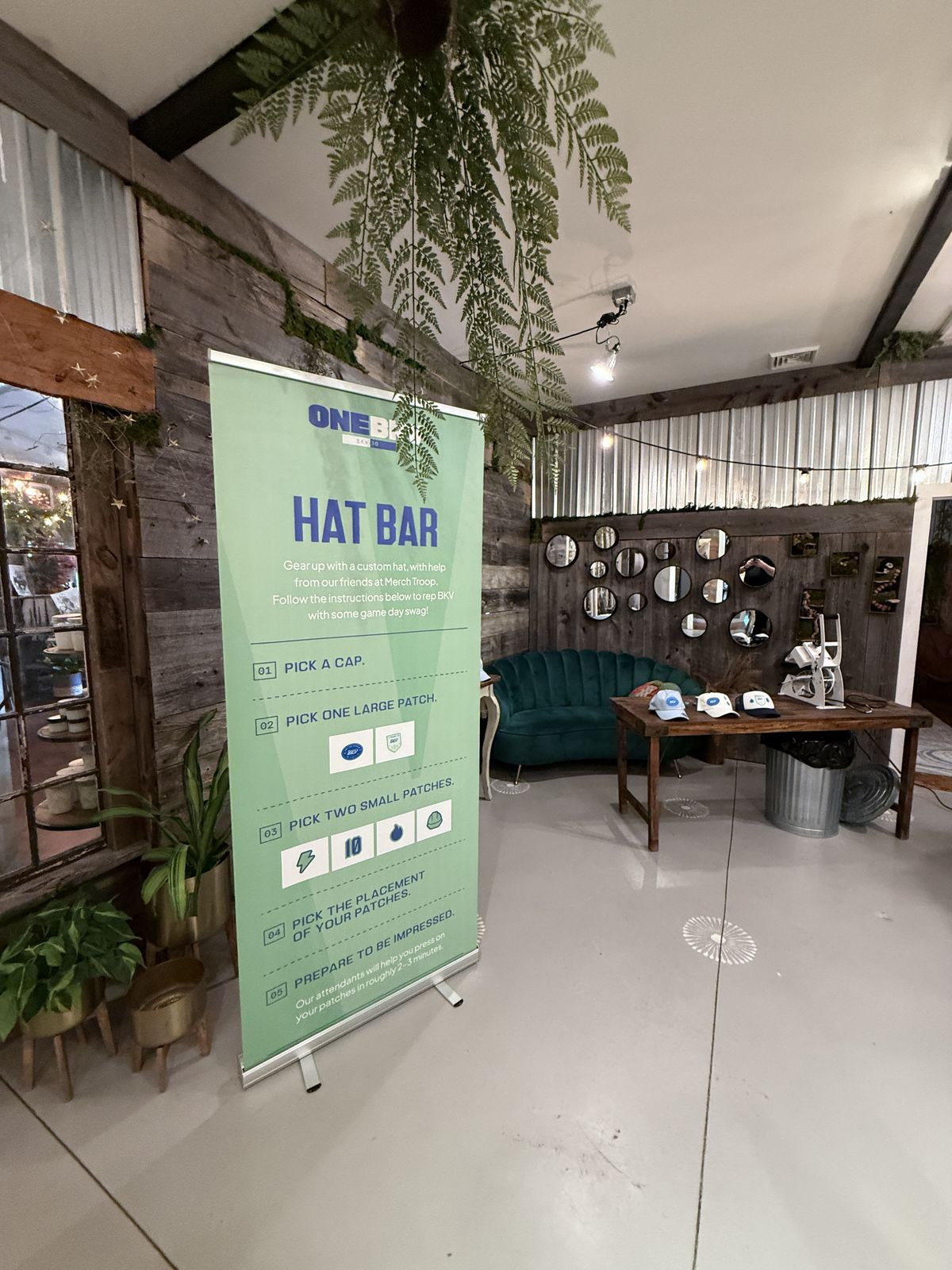Step-by-step hat bar menu banner beside a lounge seating area at a private venue party